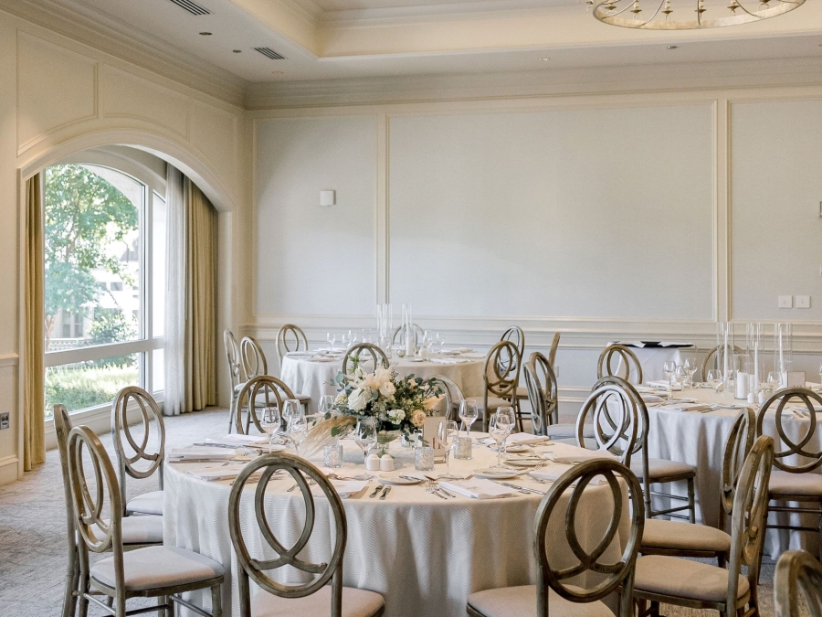 The Palmer Room in the Champions Ballroom at the Harbour Town Clubhouse setup with large round tables for a wedding. 