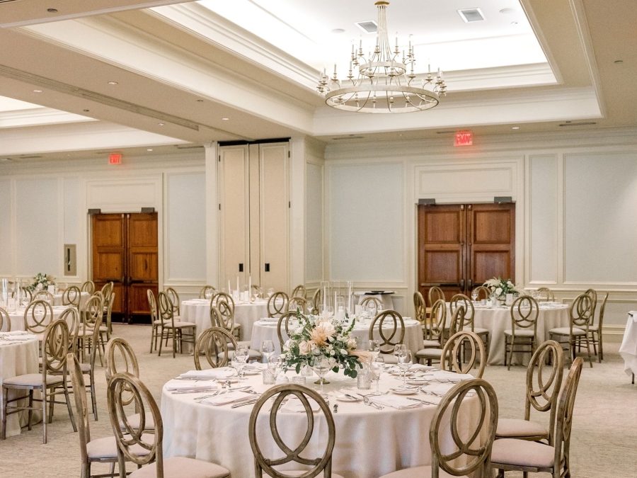 The Watson Room in the Champions Ballroom setup for a wedding with large round tables.