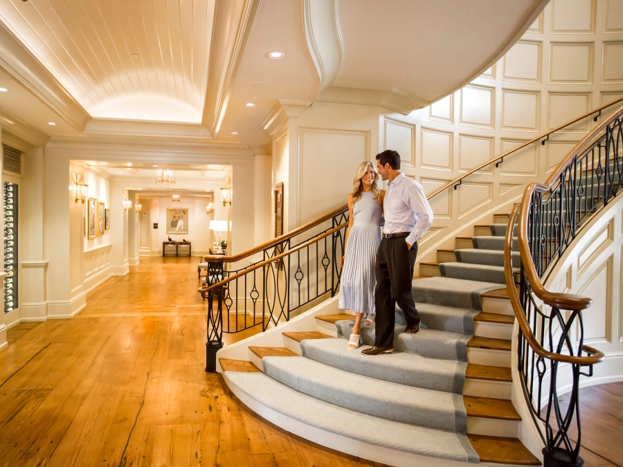 A couple walking down a grand staircase 