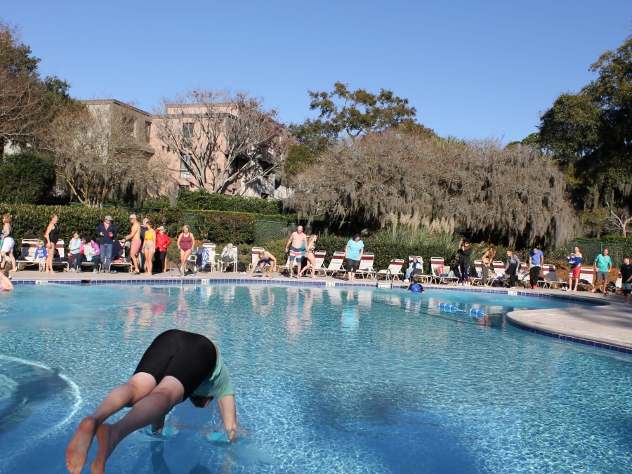 A man diving into the Harbour Town Pool for the Annual Polar Bear Plunge on New Year's Eve.