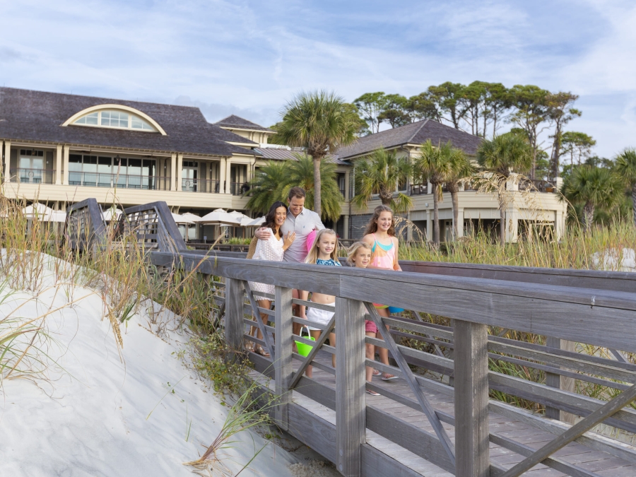 family walking towards the beach