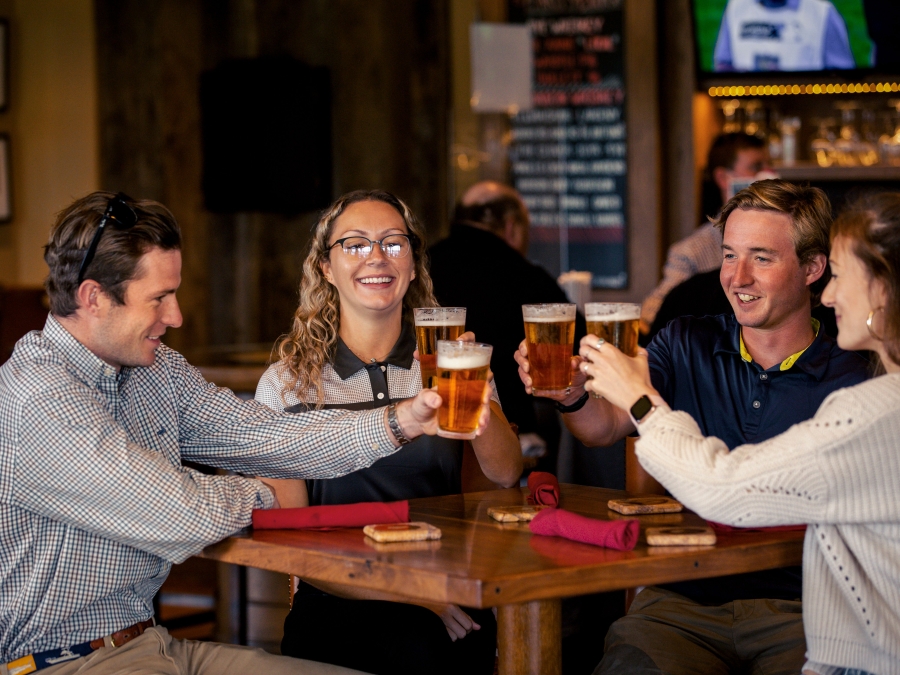 People cheer-sing with beer at Fraser's Restaurant 