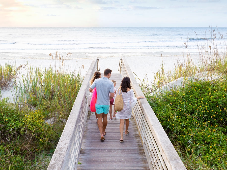 A family walking out to the beach from the Sea Pines Beach Club.