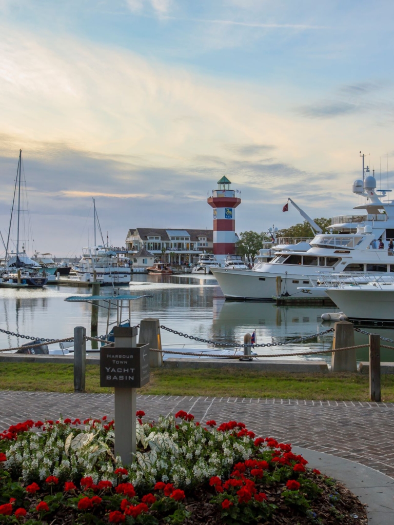 The Harbour Town Yacht Basin at sunset with the RBC logo on the Lighthouse for the Heritage PGA Golf Tournament. 
