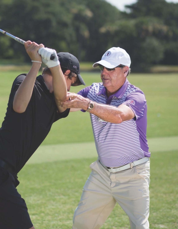 Golf coach teaching a man 