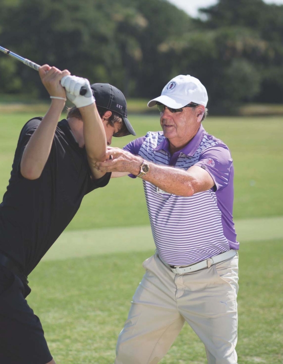Golf coach teaching a man 
