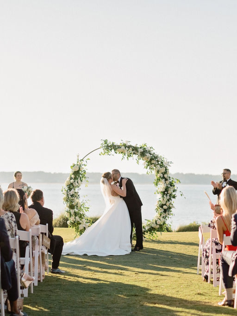Bride and Groom's first kiss at their wedding ceremony on the 18th Lawn of Harbour Town Golf Links at The Sea Pines Resort.