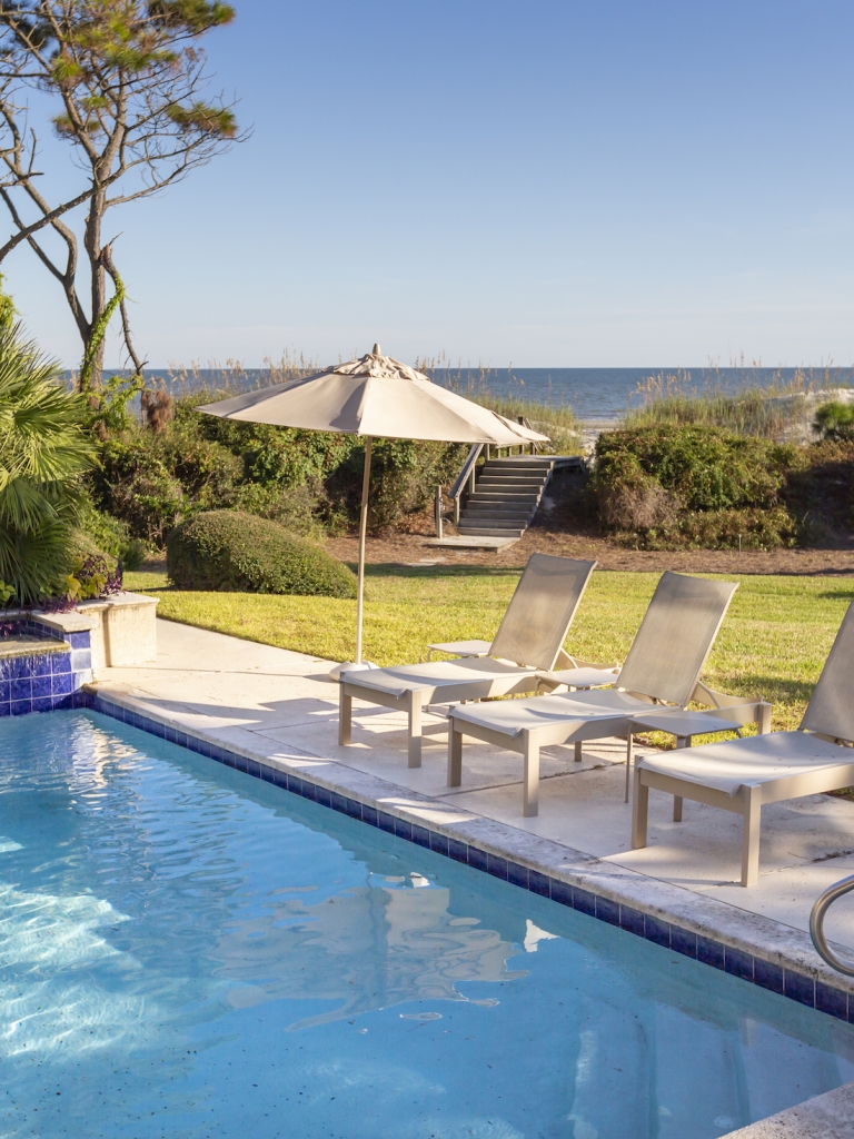 Pool and lounging chairs at a Sea Pines Villa 