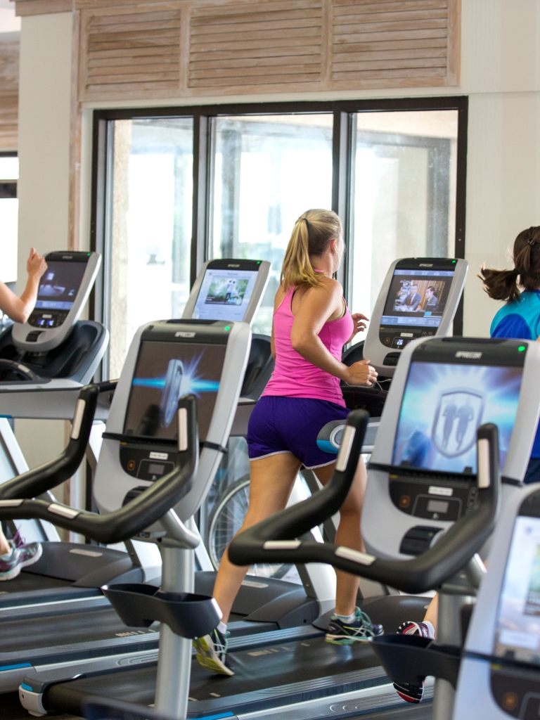 People running on treadmills in the fitness centre 