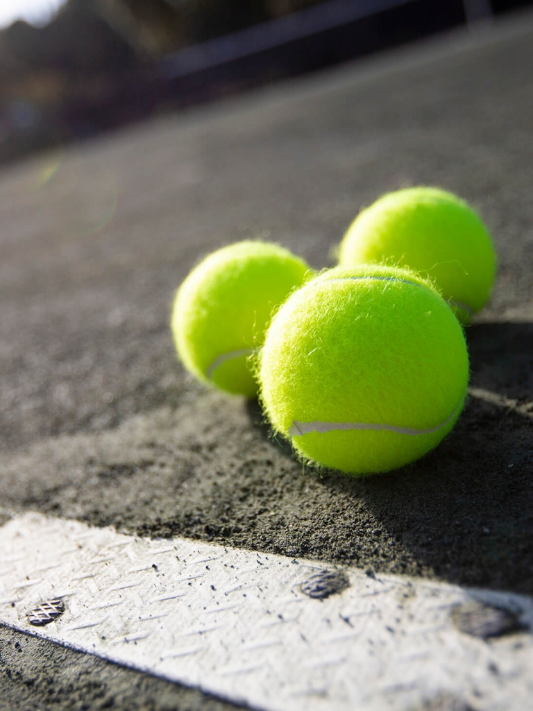 Three tennis balls on the tennis court 