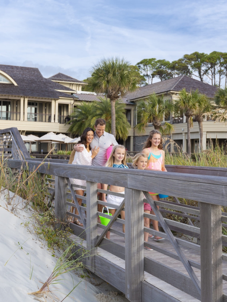 family walking towards the beach