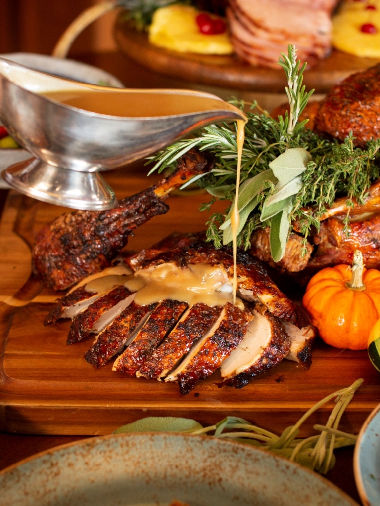 Gravy being poured over freshly cut Turkey for a Thanksgiving meal at The Sea Pines Resort. 