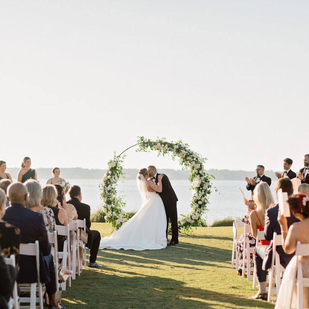 Bride and Groom's first kiss at their wedding ceremony on the 18th Lawn of Harbour Town Golf Links at The Sea Pines Resort.