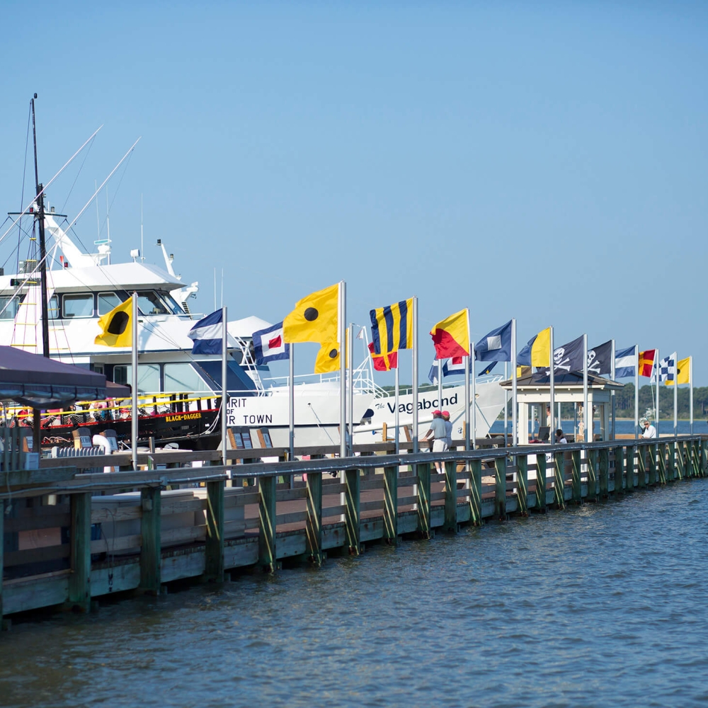 Wharf with flags and boats docked 