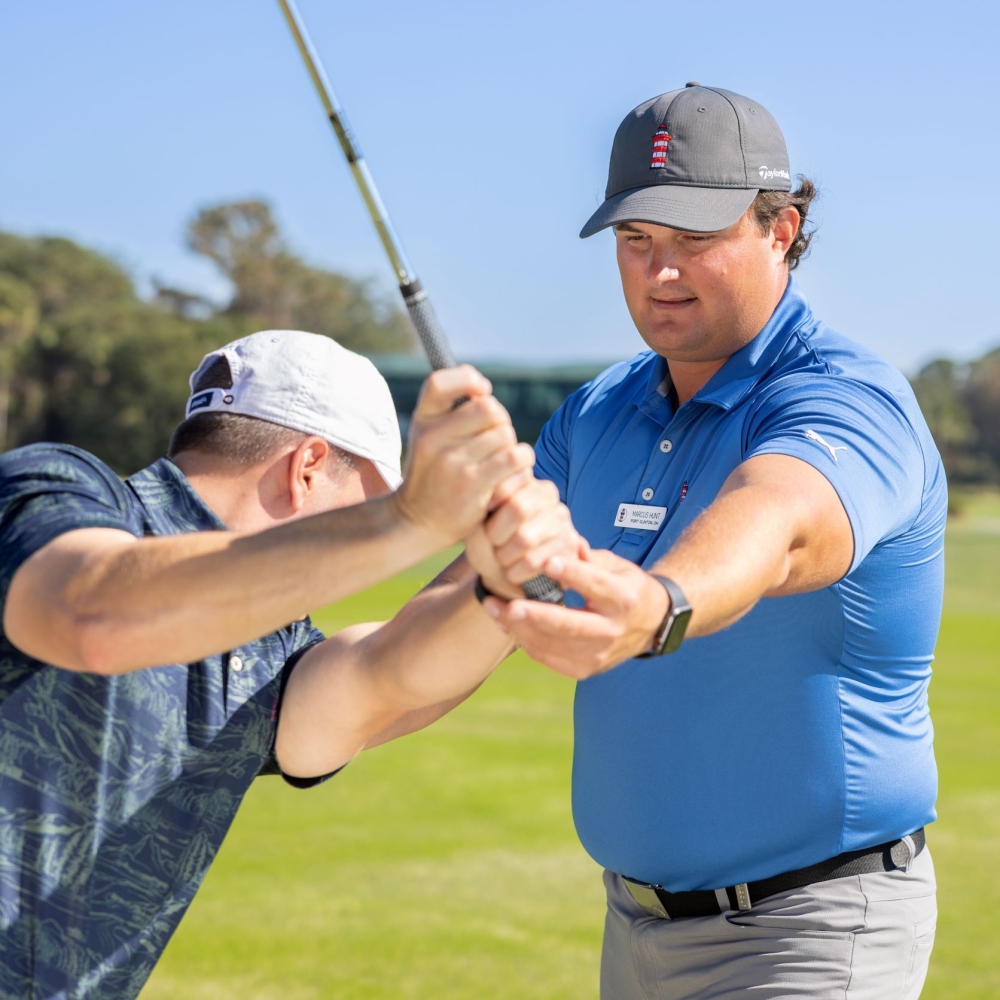Marcus Hunt helping a client fix his swing. 
