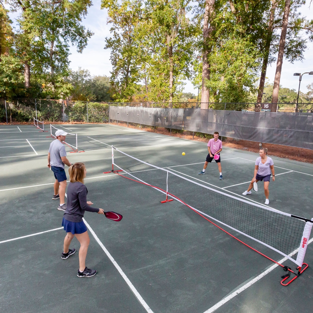 Four people playing pickleball 