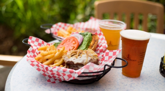 Photo of a burger, fries, and beer